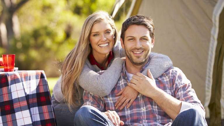 couple in flannel hugging | mccrae dental