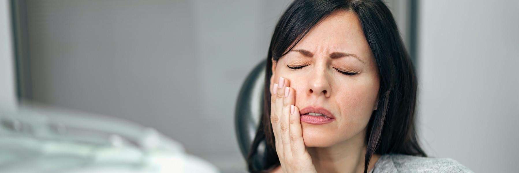 woman in pain | emergency dentist mccrae